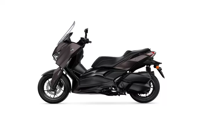 Side view of a dark Yamaha XMAX sport scooter with a windshield