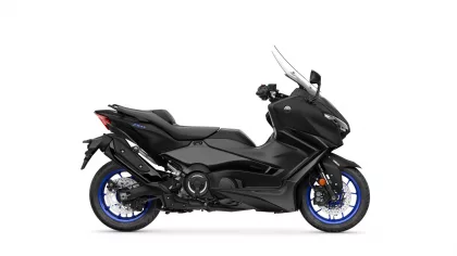 Side view of a black Yamaha TMAX scooter with blue rims and sporty styling