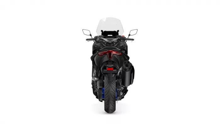 Rear view of a black sport motorcycle with a tall clear windshield and red taillight highlight