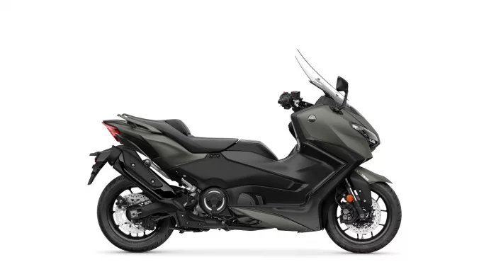 Side view of a dark gray Yamaha sport-t motorcycle with windshield and exposed engine