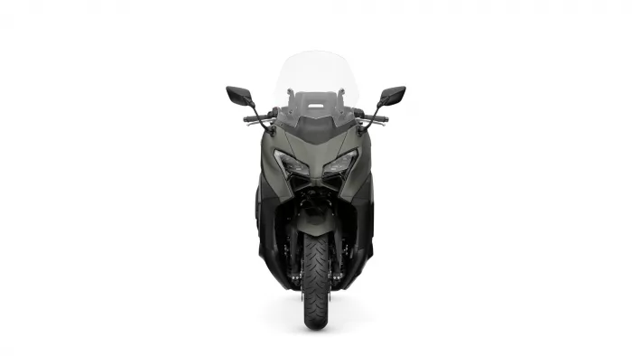 Front view of a grey-green adventure motorcycle with a tall windscreen and angular dual headlights facing the camera