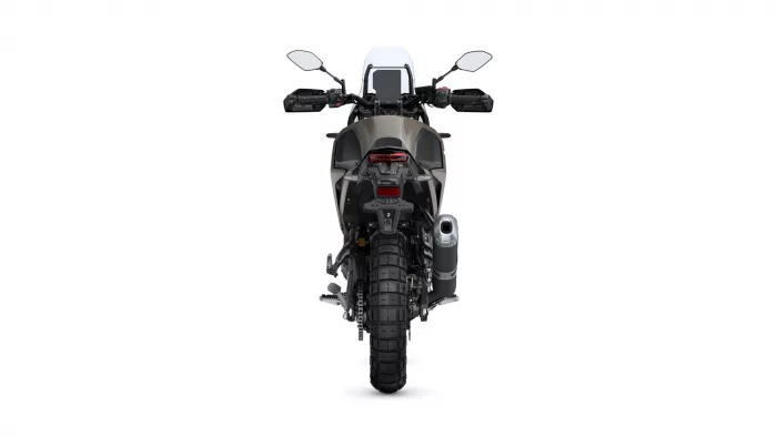 Rear view of a sport-tours motorcycle with wide knobby rear tire and dual-sport stance on a white background.
