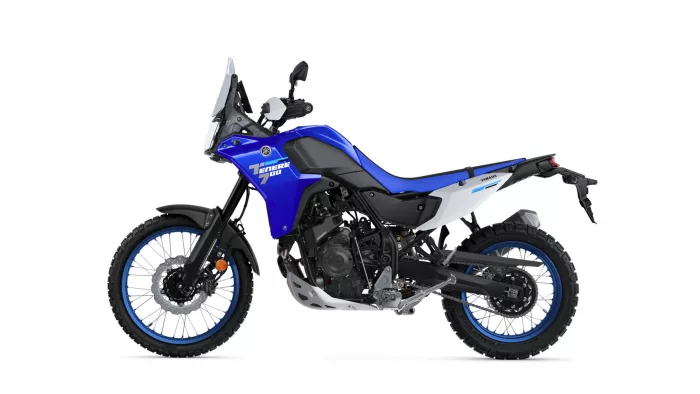Blue Yamaha Tenere 700 adventure motorcycle photographed from the left side, showing off-road tires and windscreen