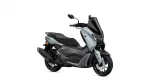 Yamaha NMAX scooter in silver and black, shown from a front-right angle with a tall black windscreen and mirrors.