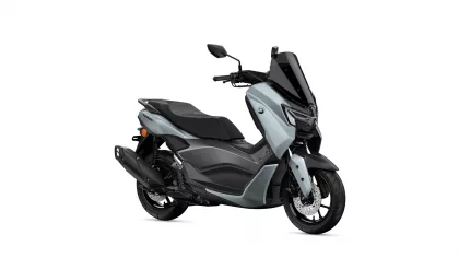 Yamaha NMAX scooter in silver and black, shown from a front-right angle with a tall black windscreen and mirrors.