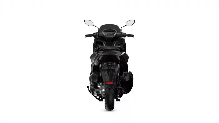 Rear view of a black sport motorcycle on a white background, showing taillights and rear wheel.