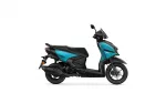Side view of a teal and black Yamaha scooter on a white background.