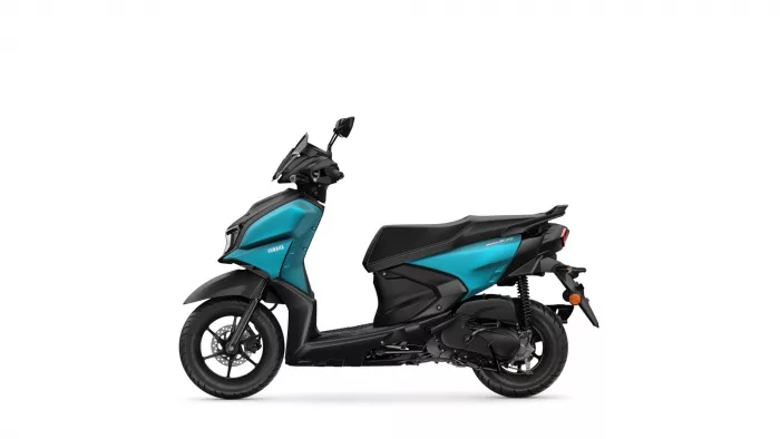 Side view of a teal and black Yamaha scooter, showing front and rear wheels and seat.