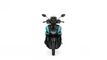 Front view of a black-and-teal motorcycle, showing windshield, handlebars, and dual headlights
