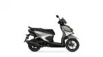 Side view of a silver and black Yamaha scooter, showing the seat, fairing, and front wheel on a white background.