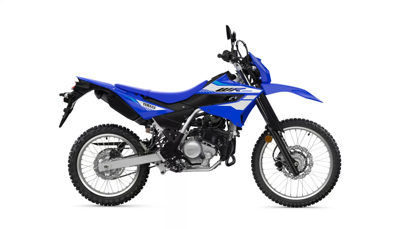 Blue Yamaha dirt bike shown in a left-side profile highlighting the seat, engine, and knobby tires.