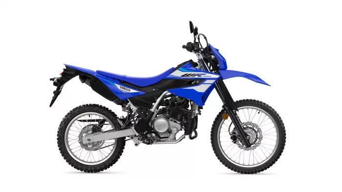 Blue Yamaha dirt bike shown in a left-side profile highlighting the seat, engine, and knobby tires.