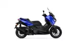 Blue Yamaha XMAX scooter shown from side and front profile against white background, highlighting the windscreen and blue bodywork.