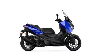 Blue Yamaha XMAX scooter shown from side and front profile against white background, highlighting the windscreen and blue bodywork.
