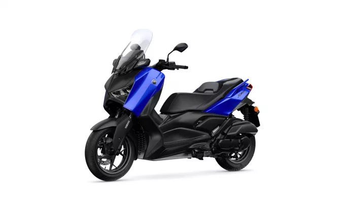 Blue Yamaha XMAX motorcycle angled on a white background, showing the front windshield and blue bodywork.