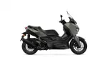 Side view of a matte olive-green Yamaha XMAX sport scooter with a windshield and disc brakes on front wheel.