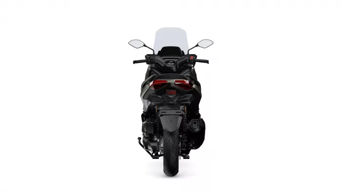 Rear view of a black sport motorcycle with a tall windshield and red taillights against a white background.