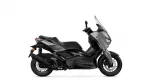 Side view of a Yamaha XMAX sport scooter in black, showing windshield and sleek bodywork.