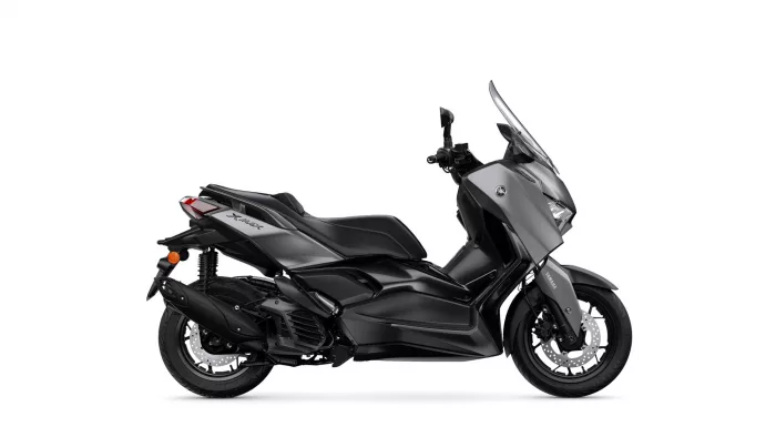 Side view of a Yamaha XMAX sport scooter in black, showing windshield and sleek bodywork.