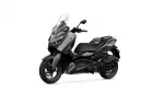 Front-left view of a dark gray Yamaha XMAX scooter with a tall clear windshield, isolated on white.