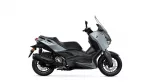 Side view of a grey Yamaha XMAX scooter with windshield on a white background.