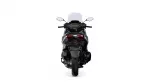 Rear view of a sport motorcycle with a tall windshield, taillights, and wide rear tire visible on a white background