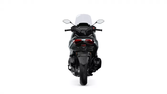 Rear view of a sport motorcycle with a tall windshield, taillights, and wide rear tire visible on a white background