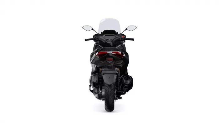 Rear view of a black sport motorcycle with a tall windshield and red taillights