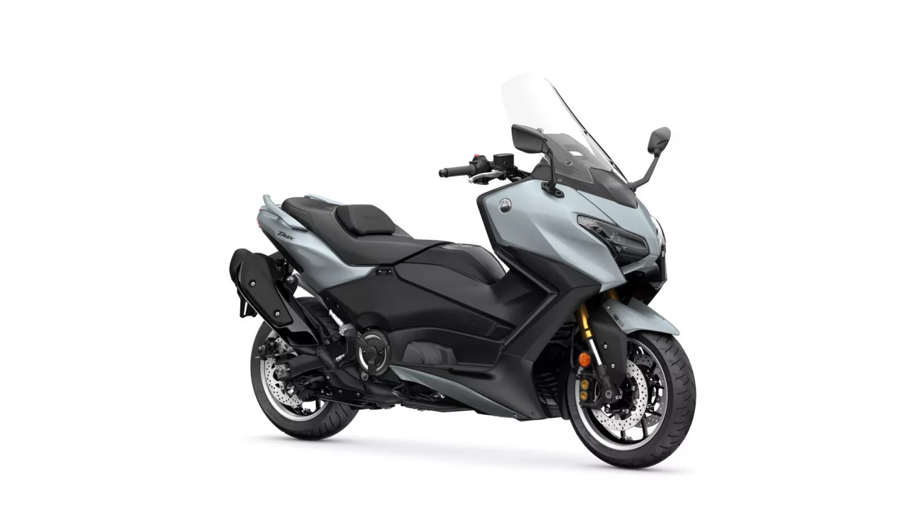 Three-quarter front view of a blue-gray Yamaha TMAX sport scooter with windshield and black accents