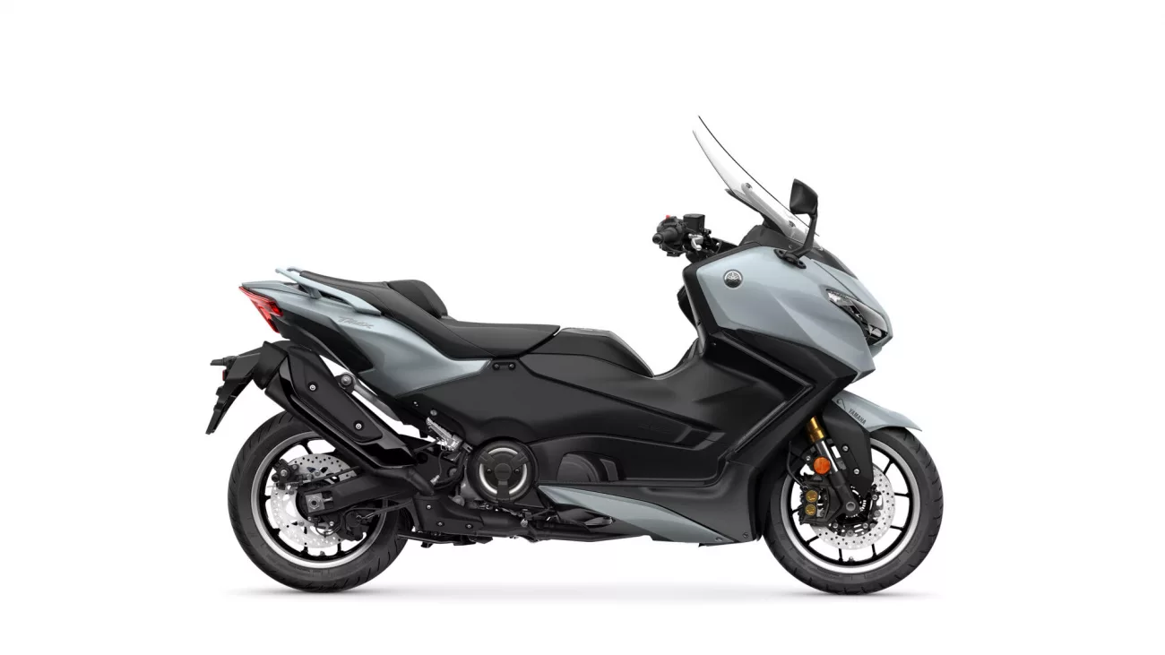Side view of a silver Yamaha Tracer sport-touring motorcycle against a white background, showing the front windscreen and exhaust.