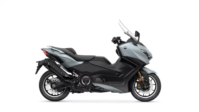 Side view of a silver Yamaha Tracer sport-touring motorcycle against a white background, showing the front windscreen and exhaust.