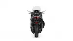 Rear view of a black sport motorcycle with a tall, clear windscreen and prominent red taillight.
