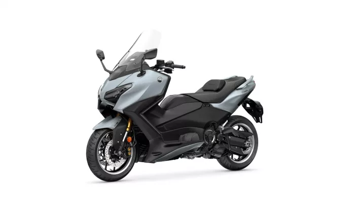 Three-quarter view of a silver-gray Yamaha TMAX sport scooter with windscreen and black seat.