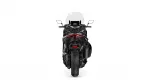 Rear view of a black sport motorcycle with a red taillight and a tall windscreen.