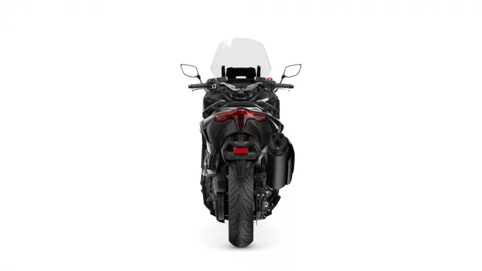 Rear view of a black sport motorcycle with a red taillight and a tall windscreen.