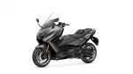 Gray Yamaha TMAX sport scooter pictured from the front-left side with a tall windshield and cockpit mirrors visible to the viewer (studio shot).