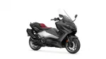 Black Yamaha sport-touring scooter with red seats and windshield, angled to show side and front profile
