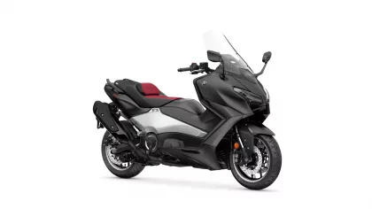 Black Yamaha sport-touring scooter with red seats and windshield, angled to show side and front profile
