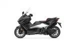 Side view of a black Yamaha TMAX scooter with a red-accented seat, shown against a white background.
