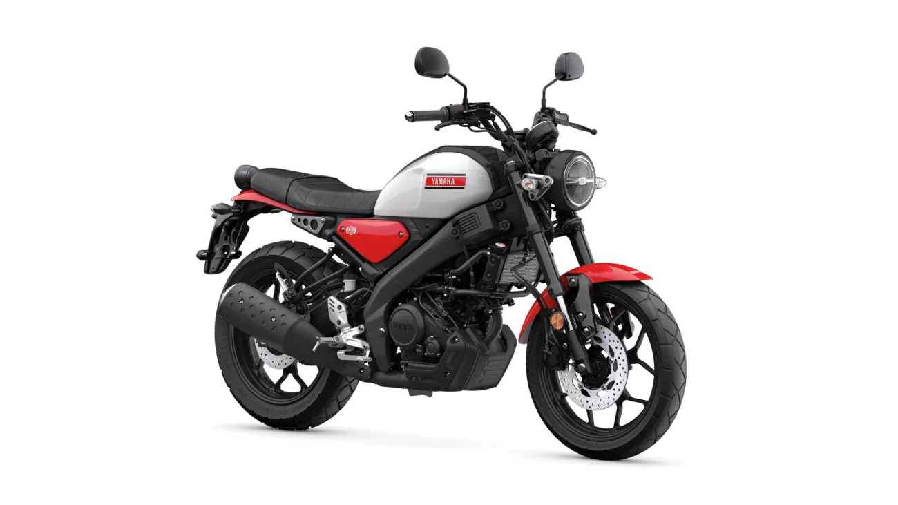 Side view of a Yamaha motorcycle with gray fuel tank, red accents, and black frame, facing right