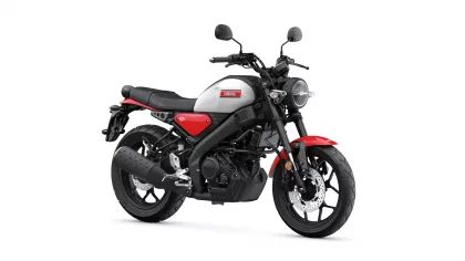 Side view of a Yamaha motorcycle with gray fuel tank, red accents, and black frame, facing right