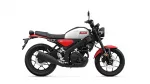 Side view of a Yamaha motorcycle with white fuel tank, red accents, and black frame.