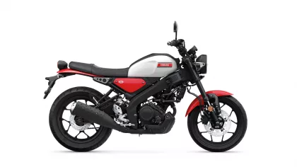 Side view of a Yamaha motorcycle with white fuel tank, red accents, and black frame.