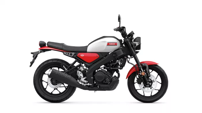 Side view of a Yamaha motorcycle with white fuel tank, red accents, and black frame.