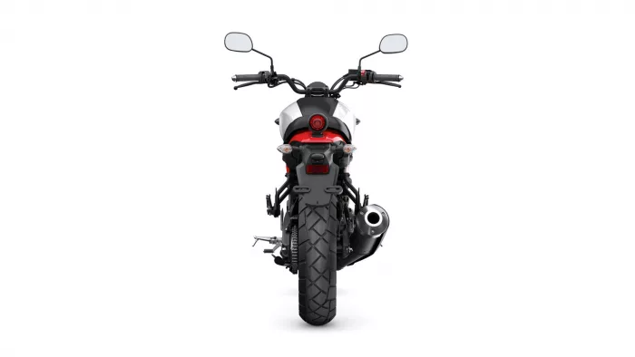 Rear view of a black-and-red motorcycle on a white background, showing taillight, mirrors, and exhaust on the right side.