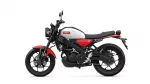 Side view of a white-and-red Yamaha motorcycle against a white background, showing its fuel tank, seat, and wheels