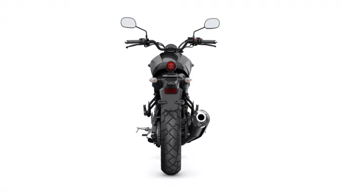 Rear view of a black sport motorcycle on a white background, showing the red taillight, wide rear tire, mirrors, and exhaust on the right.