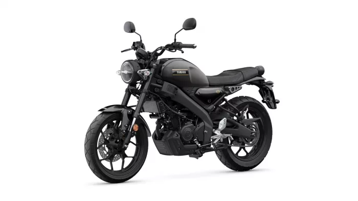 Black Yamaha motorcycle, left front three-quarter view, showcasing round headlight and sleek matte-black body.