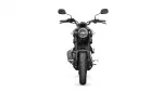 Front view of a black Yamaha motorcycle facing the camera, headlight centered and handlebars visible above the tire's tread.