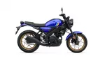 Side view of a blue Yamaha motorcycle with gold wheels and black frame, showing the fuel tank and seat